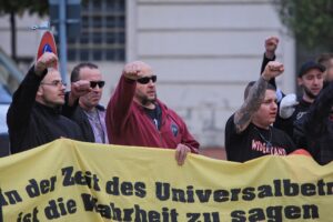 Personen hinter einem Transparent auf einer rechten Demonstration